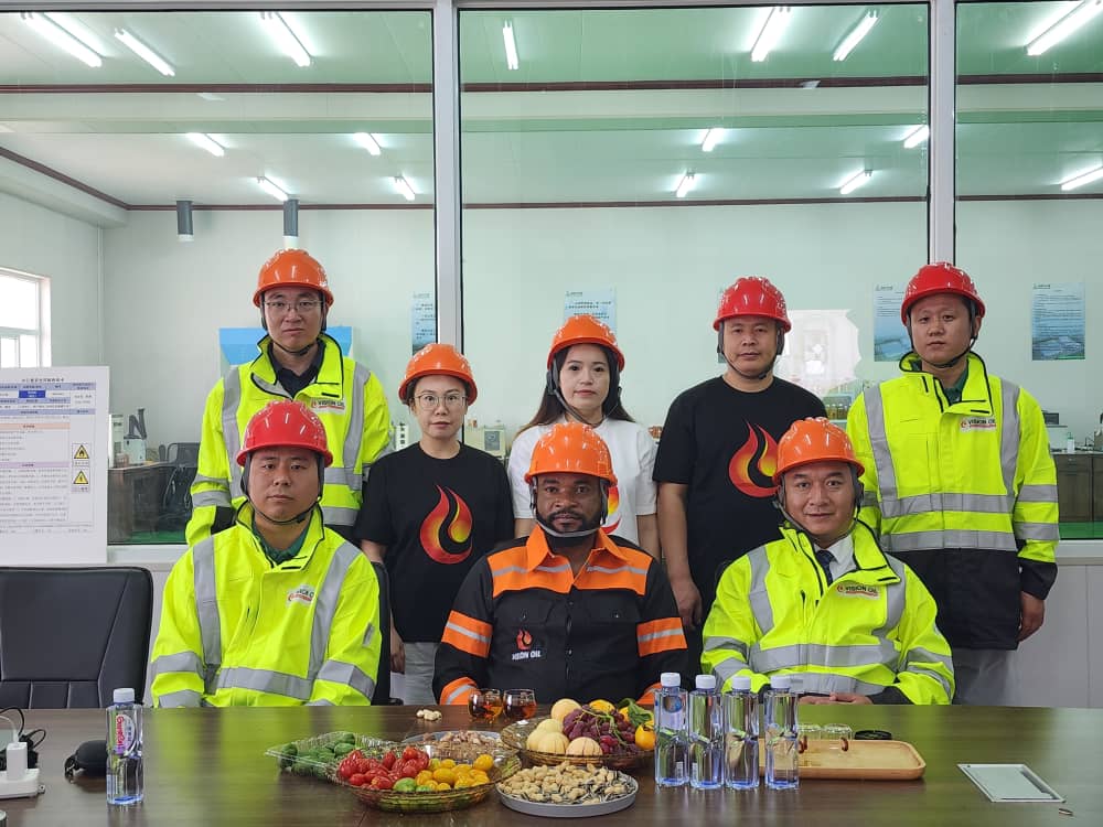 Vision Oil delegation with partner staff in safety gear
