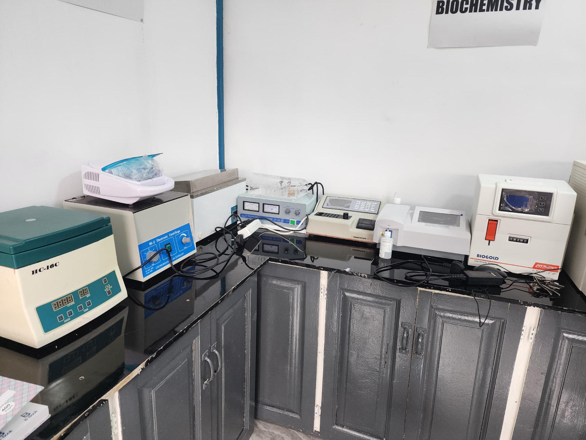 Biochemistry laboratory bench with centrifuges and analyzers at Vision Medical Diagnostic Center